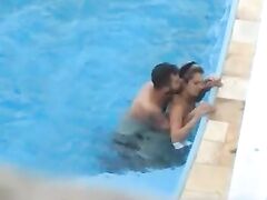 Passionate couple makes sexual intercourse in public swimming pool while hidden voyeur records